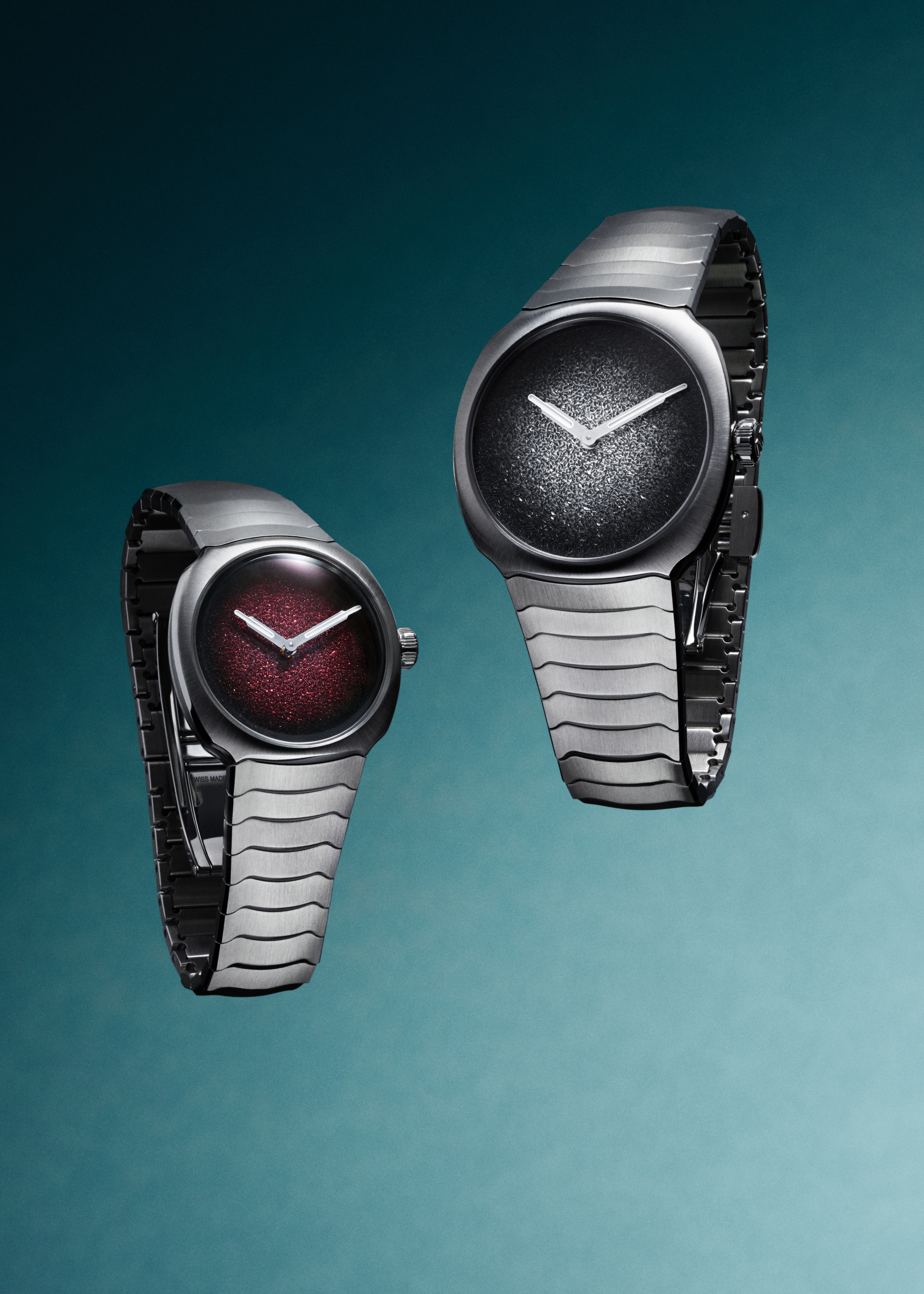 Two H. Moser & Cie. Streamliner Two Hands watches with burgundy and silver fumé dials on steel bracelets.